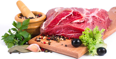 raw slab of beef on a cutting board