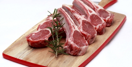 raw rack of lamb on a cutting board